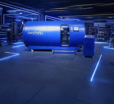 Blue-lit performance facility with an OxyHelp Industry chamber
